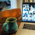 Teilnehmende einer Videokonferenz_grüne Teetasse vor Monitor